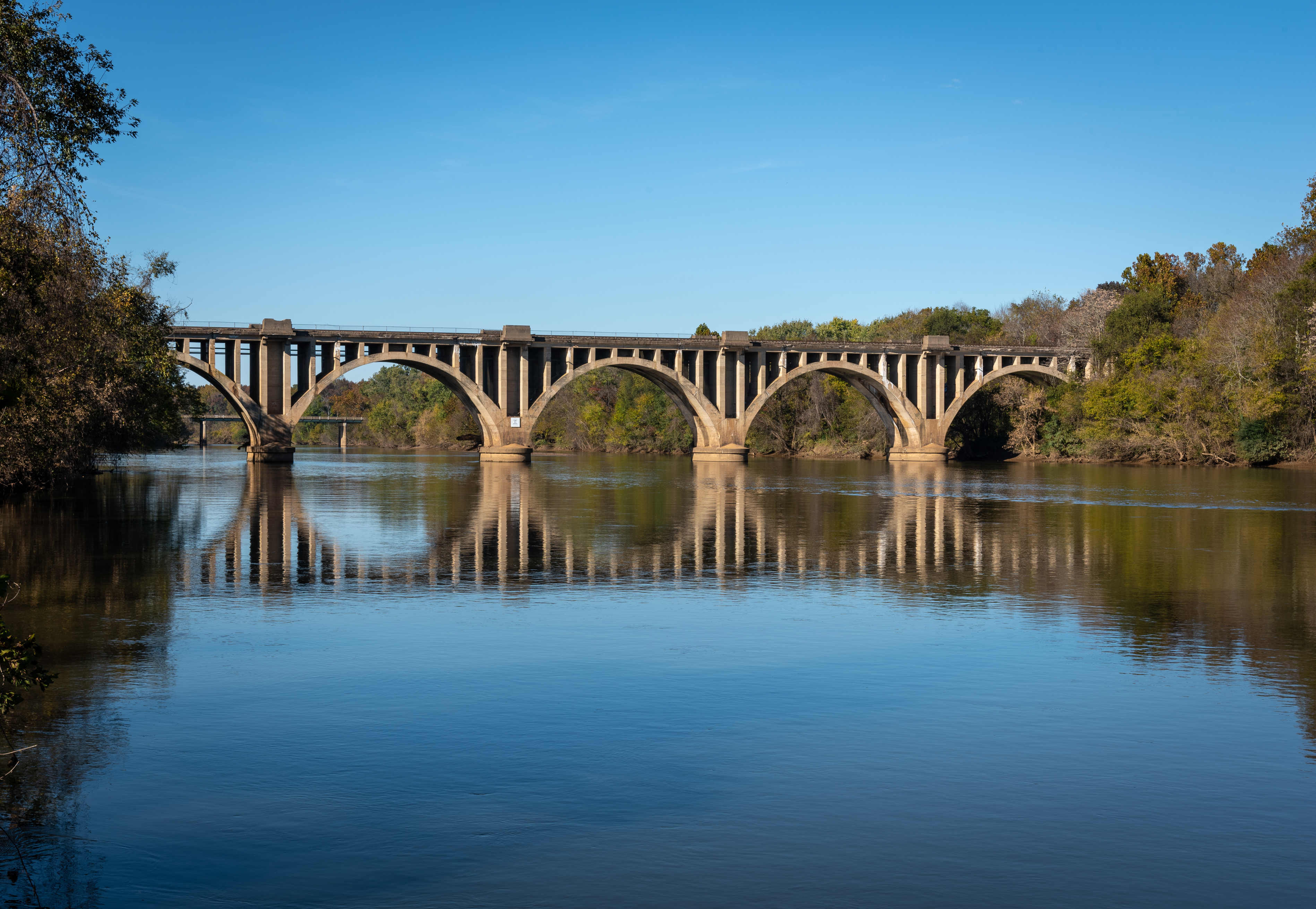 River bridge in Stafford, VA reflecting in the water below it with room for copy space above and below it.